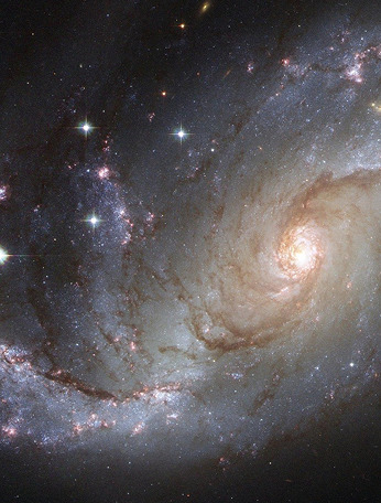 A white spiral arm galaxy upon a starry backdrop