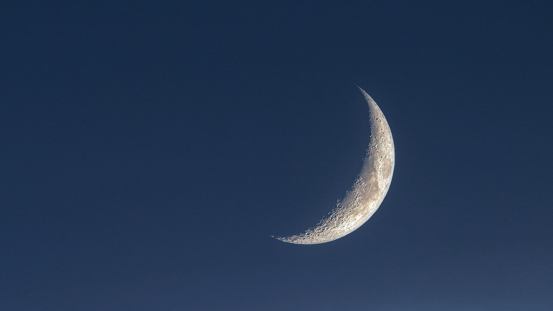 A silvery crescent moon